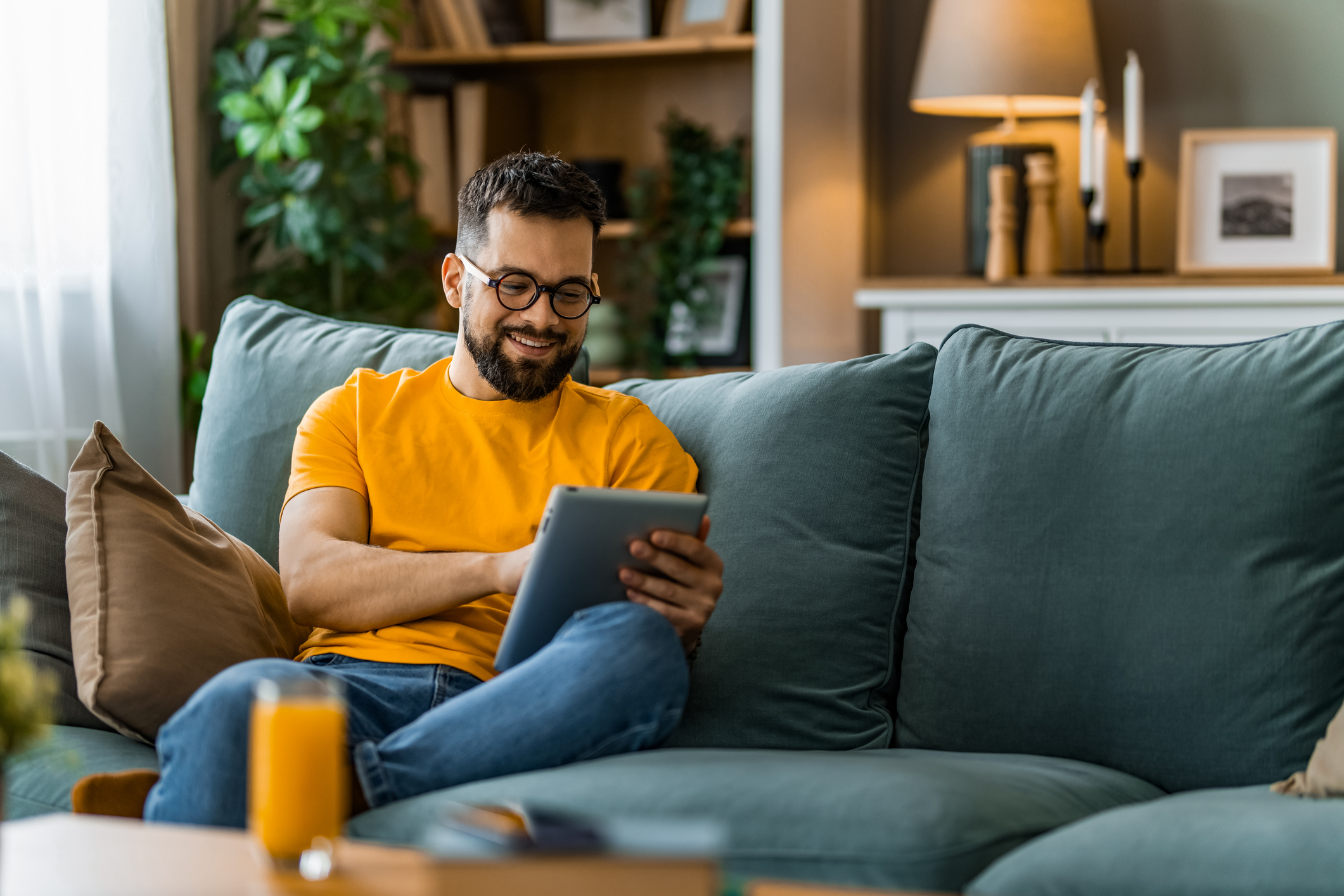 Man on Couch Using Tablet
