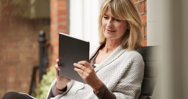 retiree viewing information on an electronic tablet