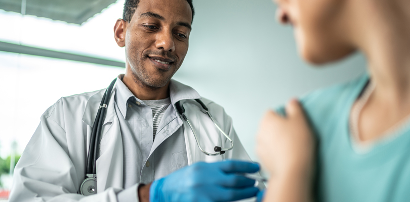 Doctor administering vaccine to patient