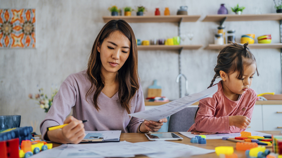 mom and child working at table