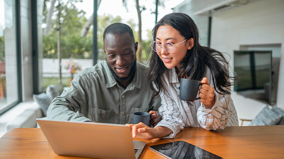 Man and woman looking at laptop computer
