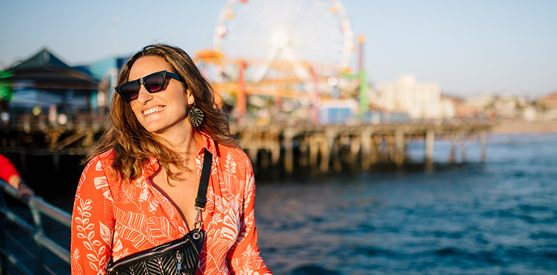 Woman smiling at fair on pier 